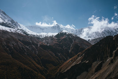 Scenic view of snowcapped mountains against sky