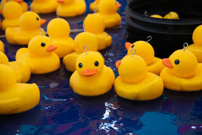 Close-up of yellow rubber ducks floating on water