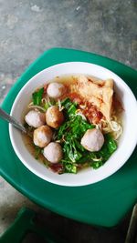 High angle view of fresh meal served in bowl on stool