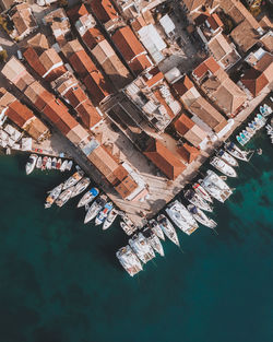 Aerial view of buildings and boats moored over sea