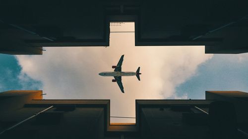 Low angle view of airplane flying in sky