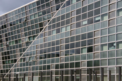 Low angle view of modern glass building in city