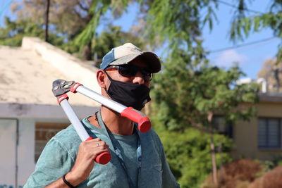 Full length portrait of man holding sunglasses