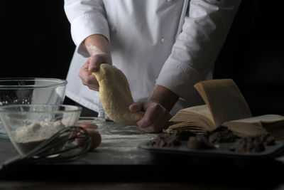Midsection of chef preparing food at table