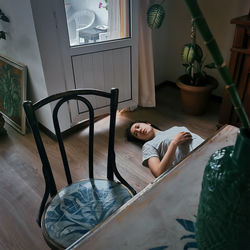 Woman lying down on bed at home