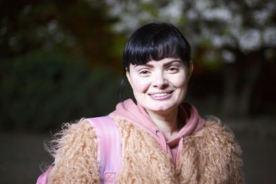 Portrait of a smiling young woman in winter