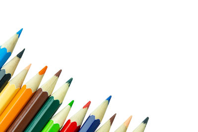 Close-up of colored pencils against white background