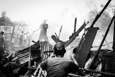 Rear view of man working against sky