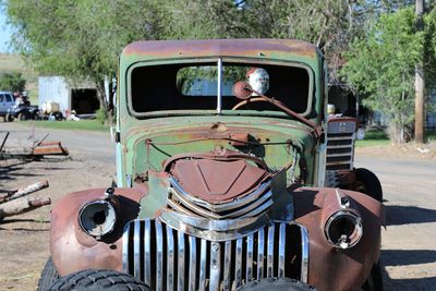 Rear view of man driving car on road