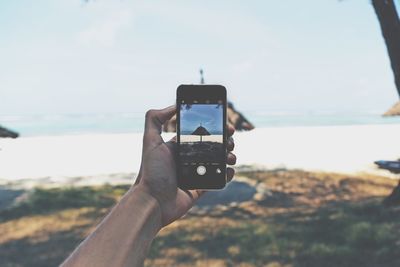 Cropped image of hand holding sea