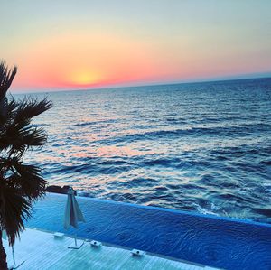 Scenic view of sea against clear sky during sunset