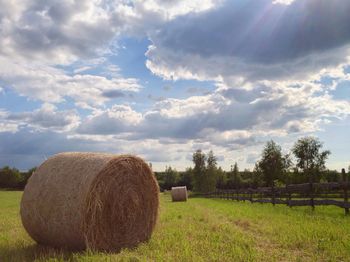 Scenic view of field against cloudy sky