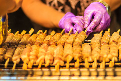 Close-up of hand holding meat at market stall