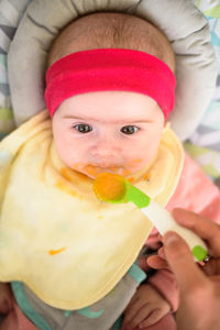 Close-up of hand feeding baby