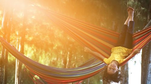 Full length of girl in hammock at sunny day