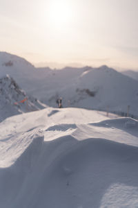 Scenic view of snowcapped mountains against sky during sunset