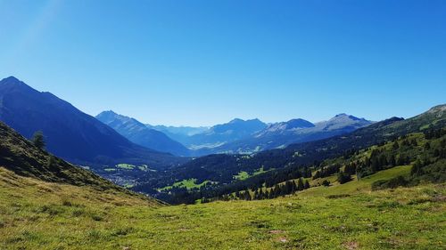 Scenic view of mountains against blue sky