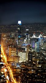 High angle view of illuminated buildings in city at night