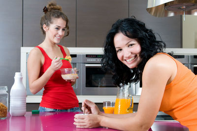 Friends having breakfast in a kitchen at home