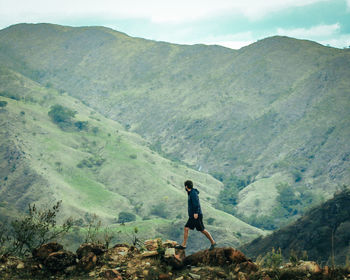 Rear view of man standing on mountain