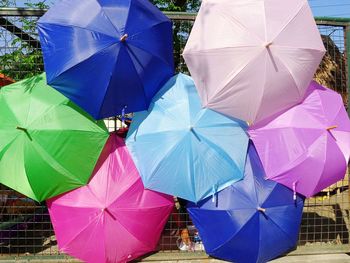 Multi colored umbrellas against sky