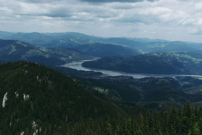 Scenic view of mountains against cloudy sky