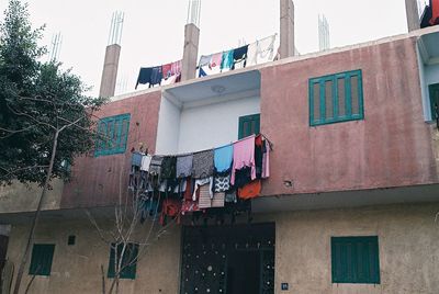 Low angle view of clothes drying outside building