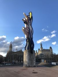 Statue of liberty against sky in city