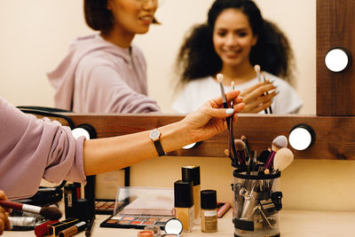 Artist doing make-up of woman in studio