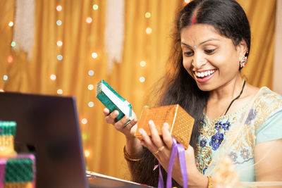 Smiling young woman using mobile phone