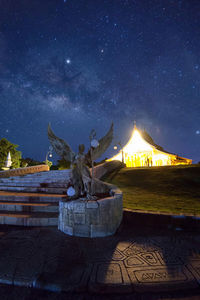 Illuminated statue against sky at night