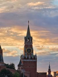 Tower of building against cloudy sky