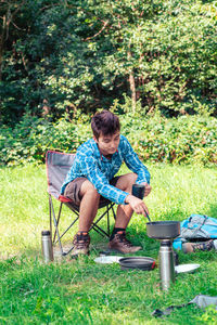 Boy preparing food on field