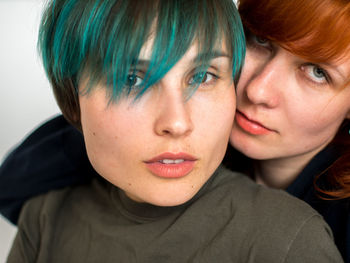 Close-up portrait of lesbian couple romancing at home