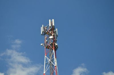 Low angle view of communications tower against blue sky