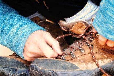 Low section of woman wearing hiking boot