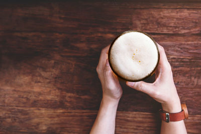 Cropped image of hand holding coffee cup