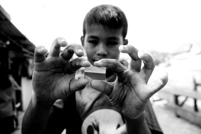 Portrait of boy holding outdoors