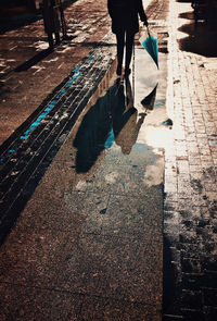 Low section of man walking on sidewalk