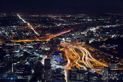 High angle view of city lit up at night