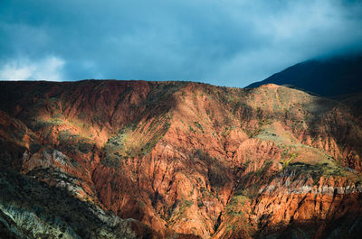 Scenic view of mountain against cloudy sky