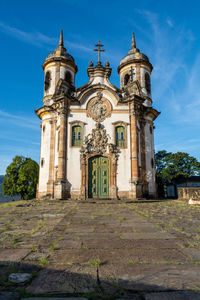 Low angle view of historic building against blue sky