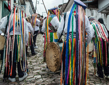 Multi colored umbrellas hanging at market stall for sale