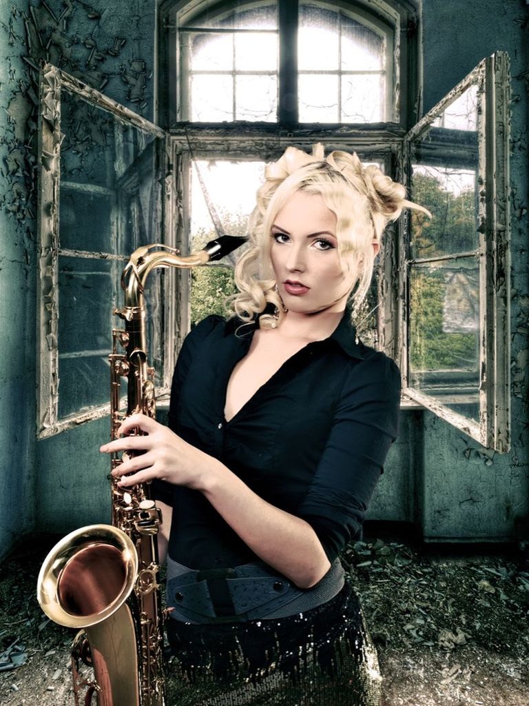 music, musical instrument, young adult, portrait, young women, one person, beautiful woman, holding, looking at camera, real people, beauty, hair, front view, artist, blond hair, women, musician, saxophone, outdoors, hairstyle