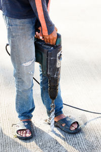 Low section of man standing on footpath