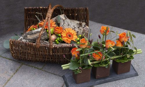 High angle view of various flowers in basket on table