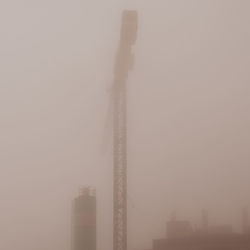 Low angle view of factory against sky