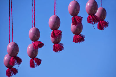 Low angle view of decoration hanging against clear blue sky