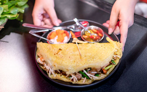 Female hand serving the set of traditional food famous in vietnam, the local vietnam food.