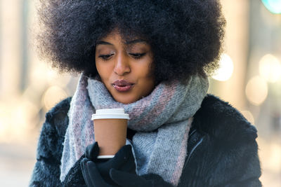 Portrait of woman drinking water